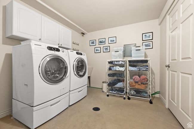 Laundry area with light carpet, cabinet space, and independent washer and dryer | Image 30