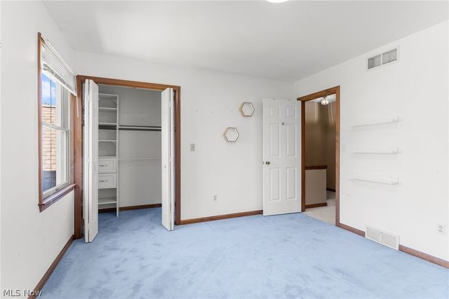 Unfurnished bedroom with a closet and carpet | Image 16