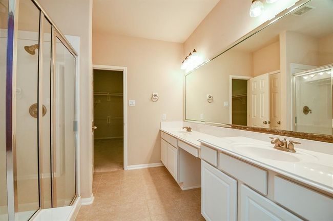 Primary bathroom features a garden tub and separate shower. | Image 18