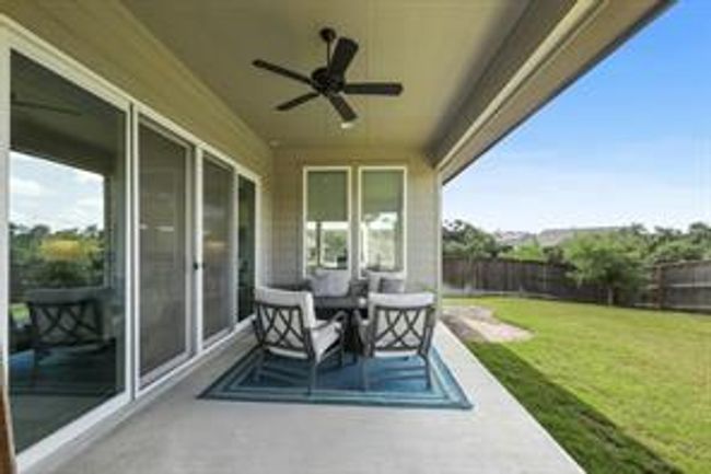Fenced backyard featuring ceiling fan | Image 14
