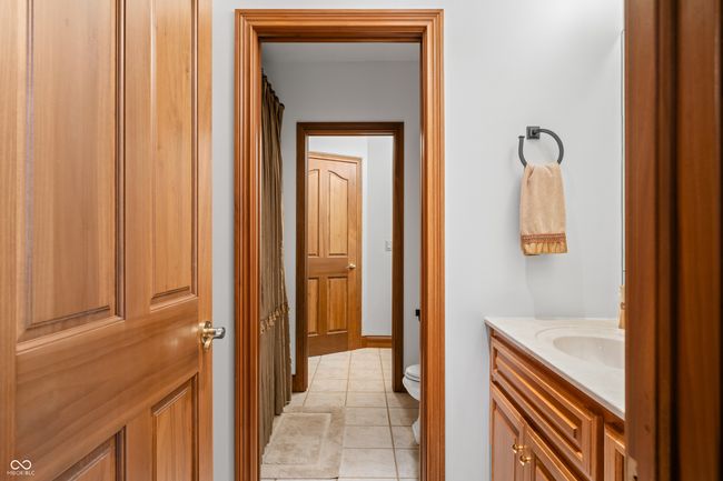 bathroom with toilet, tile patterned flooring, and vanity | Image 89