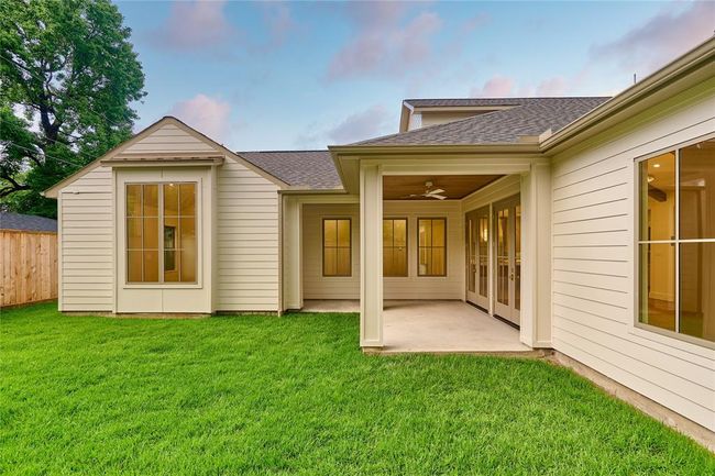 The backyard features a covered patio, perfect for peaceful morning relaxation or evening gathering. | Image 45