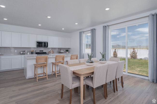 Dining area featuring recessed lighting and light wood-style flooring | Image 23