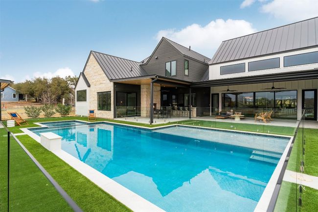 Lounge by the shimmering pool and hot tub, both framed by immaculate turf that keeps maintenance minimal | Image 32