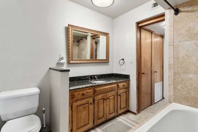 Full bathroom featuring visible vents, toilet, vanity, and bathing tub / shower combination | Image 28
