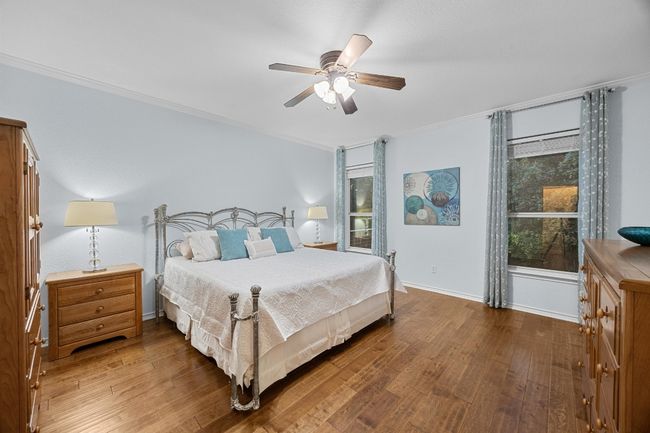 The primary bedroom is a spacious retreat. It overlooks the backyard. | Image 7