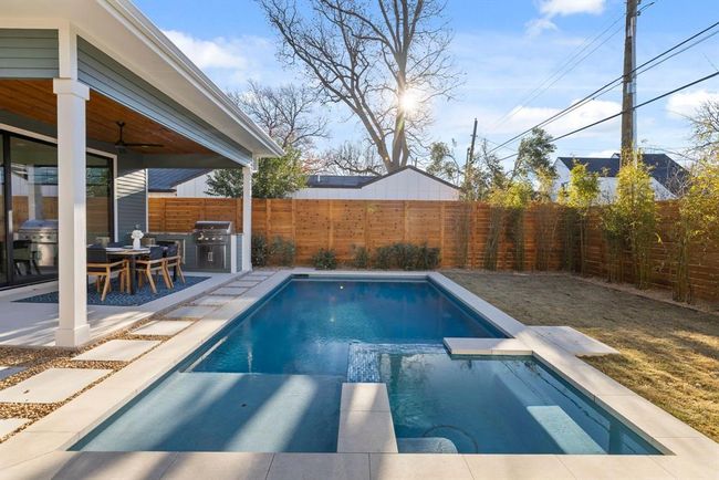 View of pool featuring a pool with connected hot tub, a fenced backyard, a grill, a ceiling fan, and a patio area | Image 34