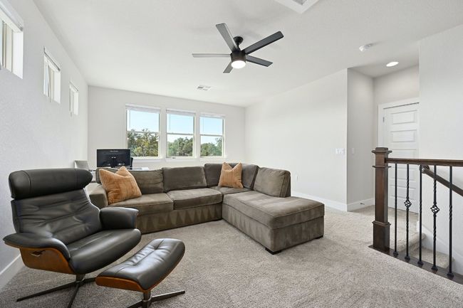 Upstairs, you'll find a generous loft area that can be used as a secondary living room, play area, or media room. | Image 22