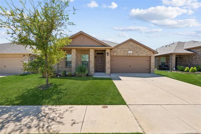 Single story home with a garage and a front lawn | Image 1