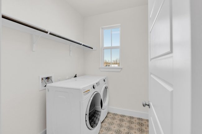 Clothes washing area with laundry area, washing machine and dryer, baseboards, and light floors | Image 35