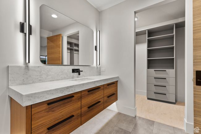 Bathroom featuring backsplash, baseboards, and vanity | Image 48
