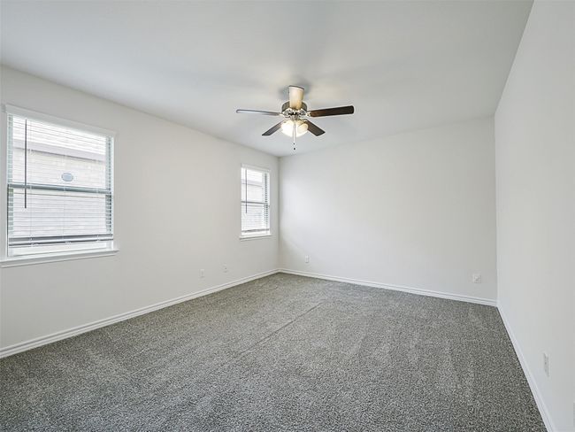 Spare room featuring ceiling fan and carpet | Image 12