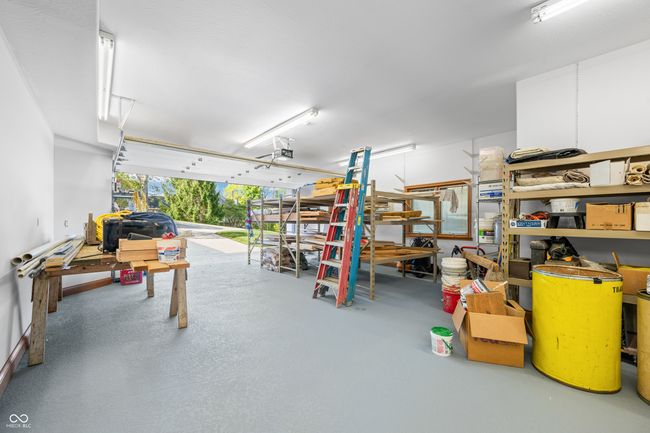 garage featuring a garage door opener | Image 100