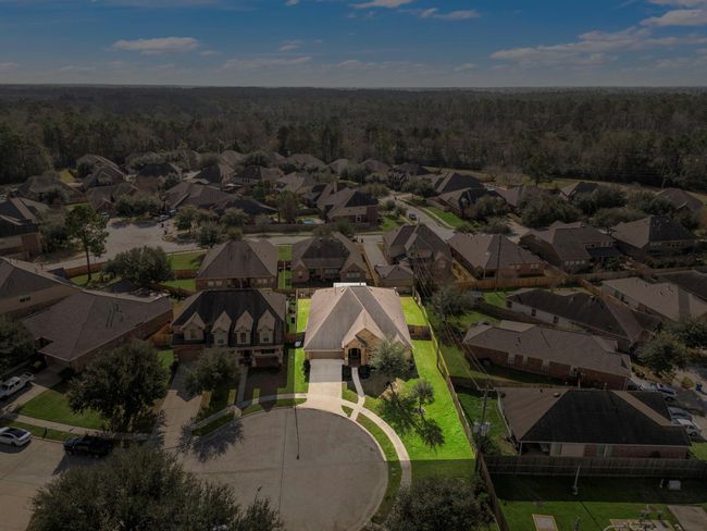 Nestled in a serene cul-de-sac, this Spring Trails property boasts a prime location with a generously-sized lot. The brick and stone exterior complements the lush landscaping, while the 3-car tandem garage offers convenience. Enjoy nearby community amenities, award-winning schools, and easy access to parks and shopping. | Image 37