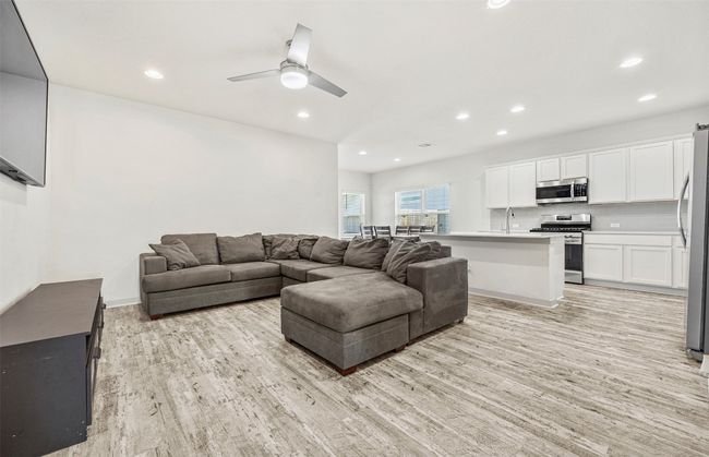 The heart of the home! This open-concept living area seamlessly connects the living room, dining area, and kitchen, perfect for entertaining and family gatherings. | Image 7
