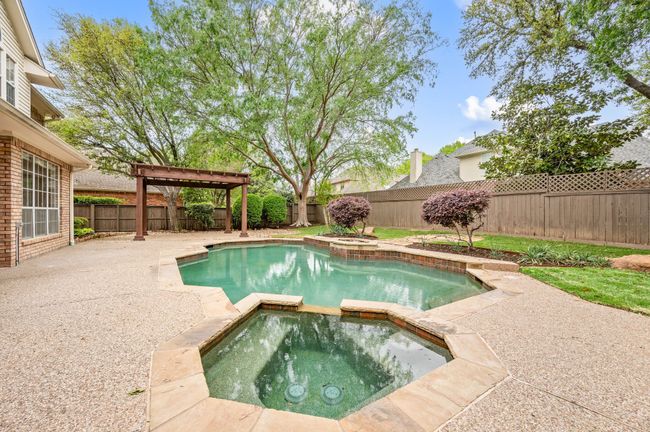 View of pool featuring a fenced backyard, a pool with connected spa, and a patio | Image 32