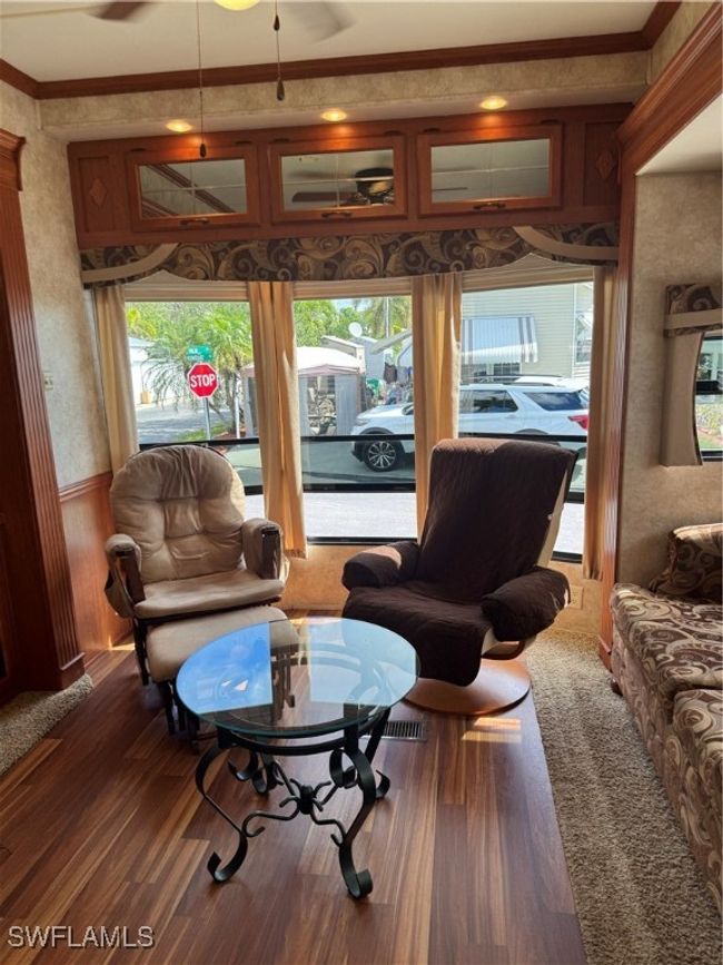 Living room with plenty of natural light, crown molding, and dark hardwood / wood-style floors | Image 25