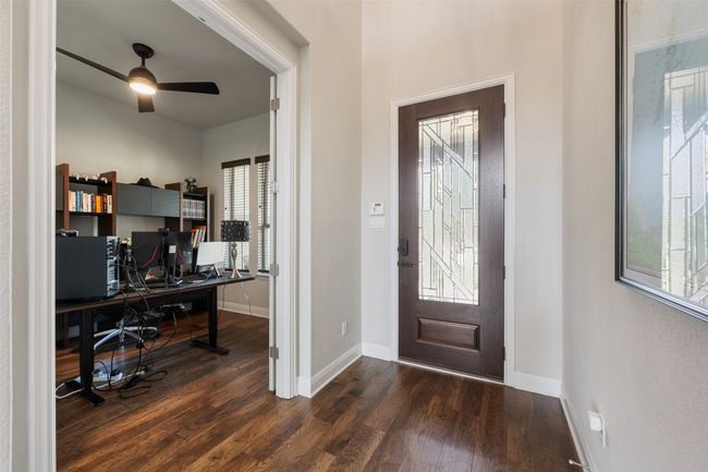 Entryway with dark wood finished floors, healthy amount of natural light, and ceiling fan | Image 6