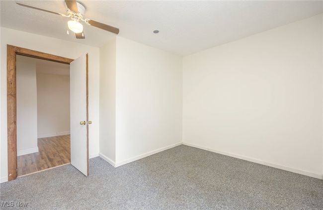 Unfurnished bonus room with carpet, baseboards, and ceiling fan | Image 15