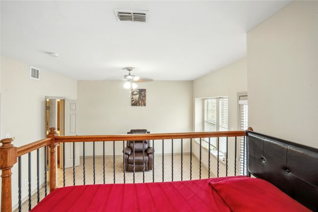 Hallway with carpet floors and vaulted ceiling | Image 21