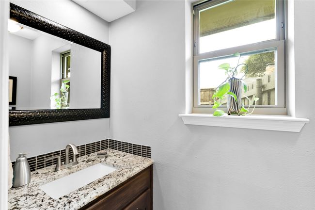 Bathroom featuring vanity and tasteful backsplash | Image 19