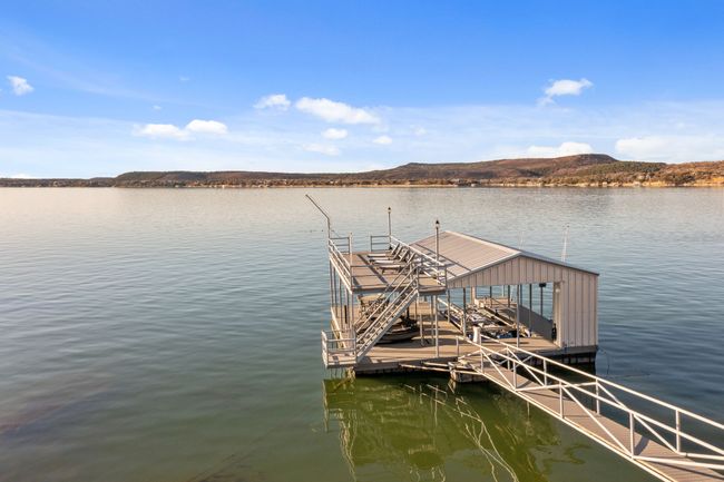 Dock area featuring a water and mountain view | Image 38