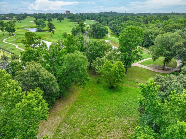 Aerial view of property's location with a large body of water and a golf course | Image 9