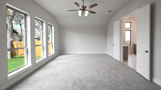 Unfurnished bedroom with lofted ceiling, light colored carpet, and a ceiling fan | Image 19