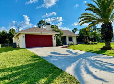 Great Curb Appearance, Screened Entry..... 2 Car Garage with Tropical Pineapple Outside Lights | Image 2