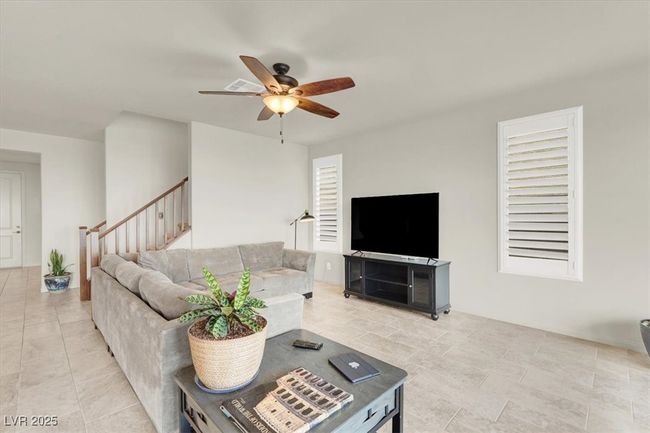 Living area featuring ceiling fan | Image 15