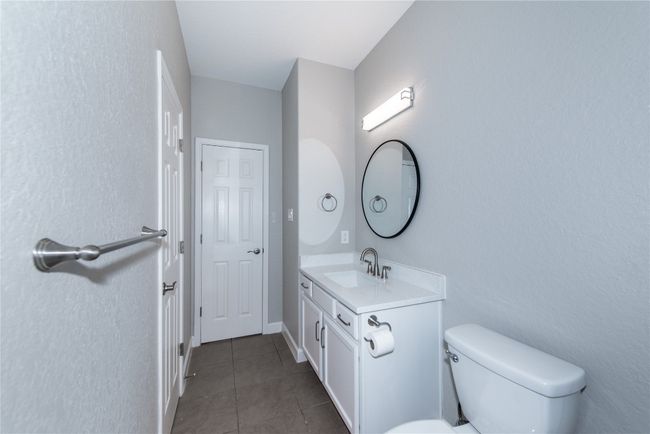 Facing entrace of secondary bathroom, door on left is linen closet door | Image 22