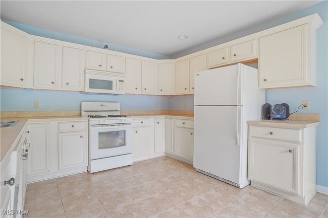 Kitchen featuring white appliances and light countertops | Image 19