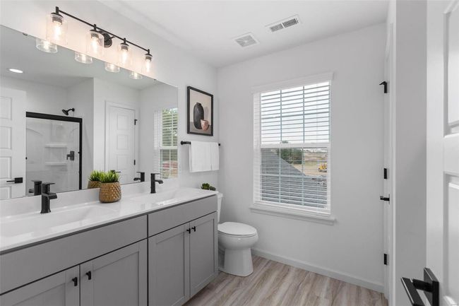 Bathroom featuring vanity, toilet, hardwood / wood-style floors, and an enclosed shower | Image 14