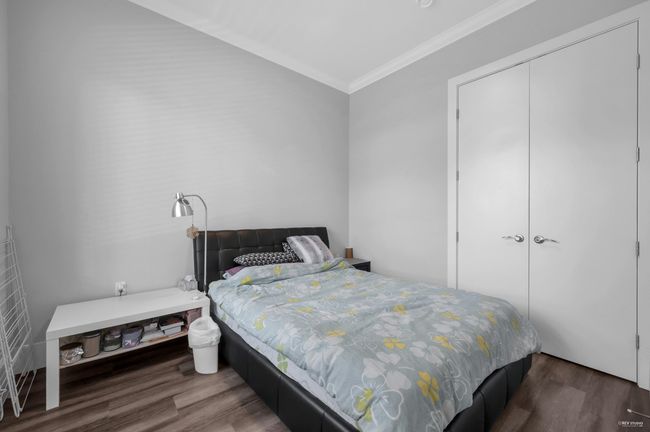 Bedroom featuring wood finished floors, ornamental molding, and a closet | Image 18