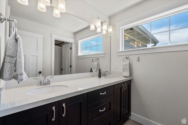 Full bath with double vanity, baseboards, and a sink | Image 41