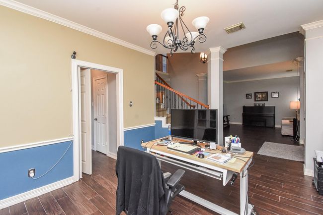 Note architectural details of chair rail trim in this room and crown molding throughout your new home! Your formal dining room is well connected to your kitchen, making serving meals seamless and perfect for both everyday dining and special occasions. | Image 6