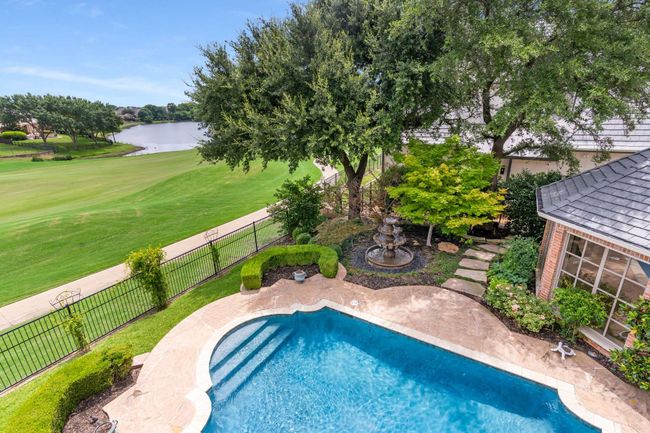 View of pool with a fenced backyard, view of golf course, and a water view | Image 33
