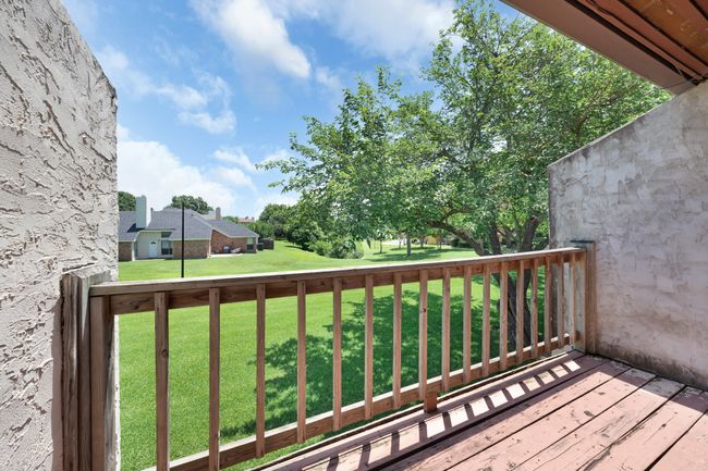 Balcony off of primary bedroom has expansive views across the greenbelt. | Image 23