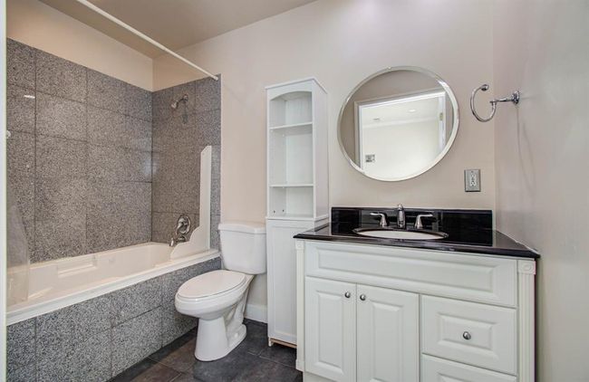 Spacious second full bath with elegant fixtures and modern design. | Image 16