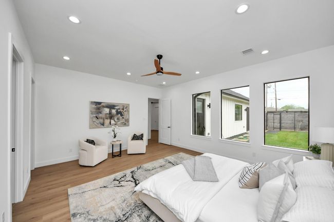 There is plenty of space for a sitting area and large windows grace the room, allowing natural light in! | Image 13
