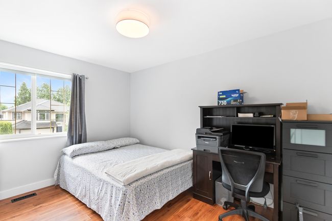 Bedroom with light wood-type flooring, baseboards, and a desk | Image 19