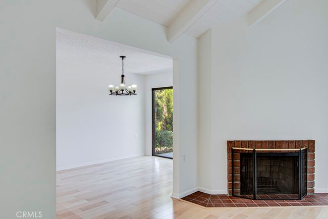 Living room fireplace and entrance to the dining room. | Image 9