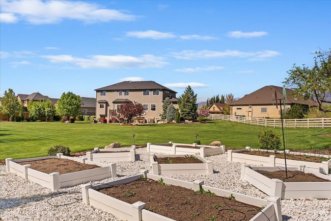 View of yard with fence, a vegetable garden, and a residential view | Image 59