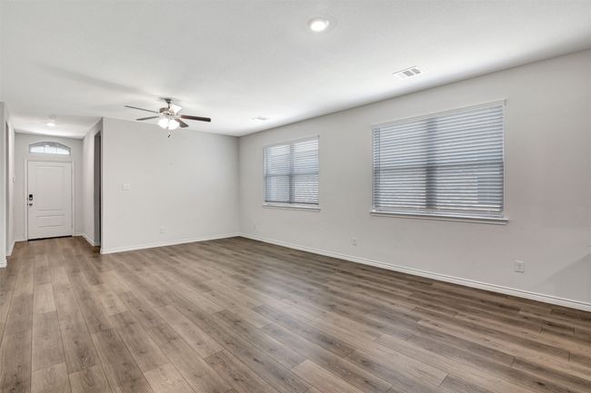 Spare room with a ceiling fan and wood finished floors | Image 12