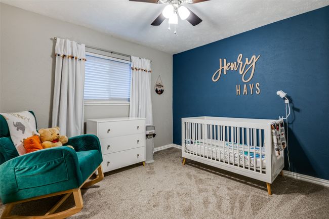 Bedroom with carpet floors, baseboards, a ceiling fan, and a crib | Image 19