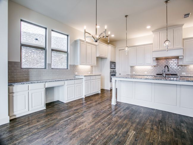 Kitchen featuring tasteful backsplash, dark wood finished floors, stainless steel appliances, light stone countertops, and recessed lighting | Image 12