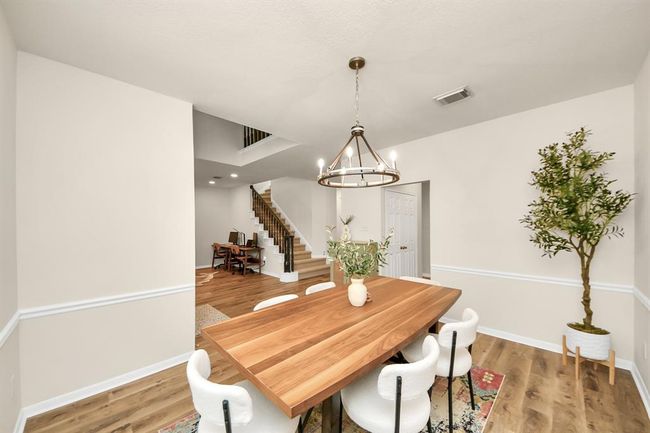 Just off the entry, the formal dining room offers the perfect setting for gatherings, with room to easily fit a full-sized dining set. Modern light fixtures add a stylish edge, and the large front-facing window fills the space with soft, natural light. | Image 5