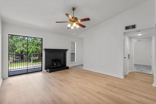 Living room features cozy fireplace and neutral finishes | Image 8