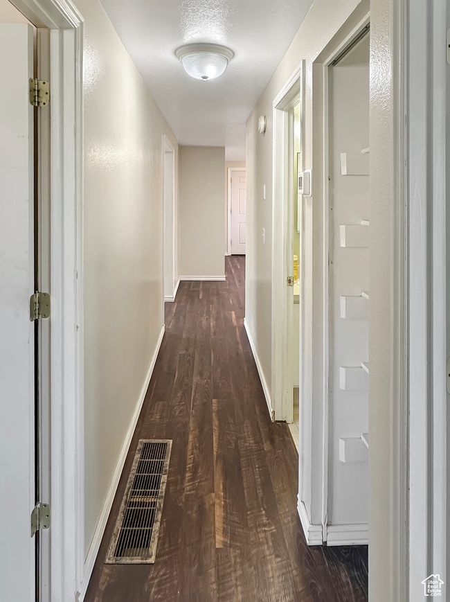 Corridor featuring dark wood-style flooring and baseboards | Image 14