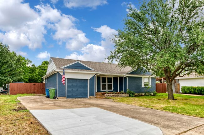 Ranch-style home with driveway, a garage, and roof with shingles | Image 35
